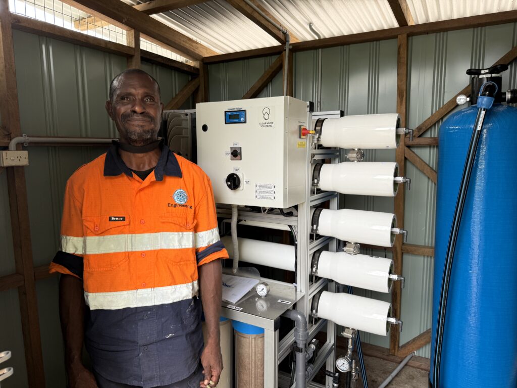 Solar Water Solutions desalination system and an engineer in an island installation shed